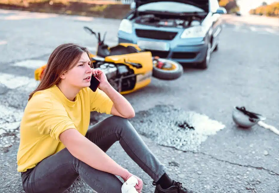 woman on phone after motorcycle accident