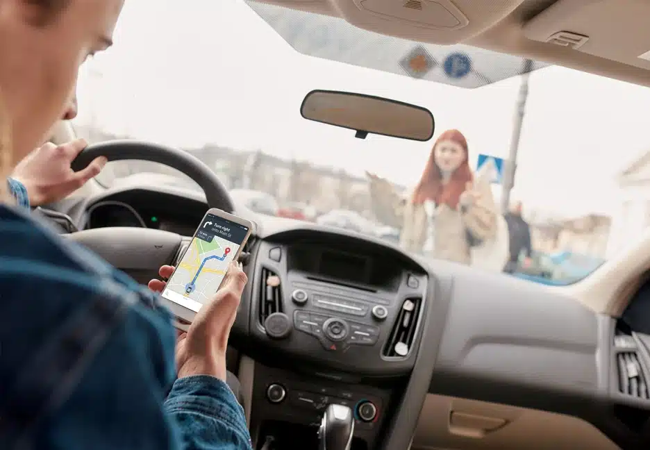 distracted driver looking at phone about to hit a pedestrian