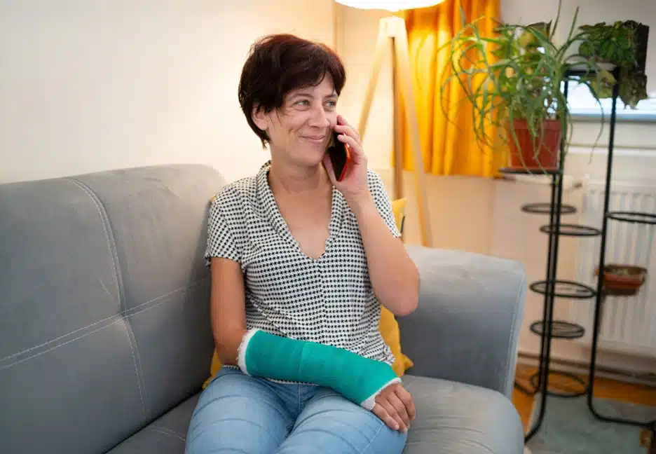 injured woman smiling on phone