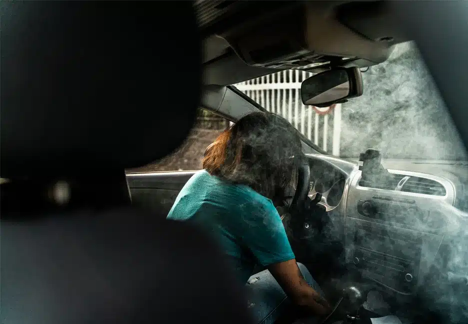 driver in car filled with smoke