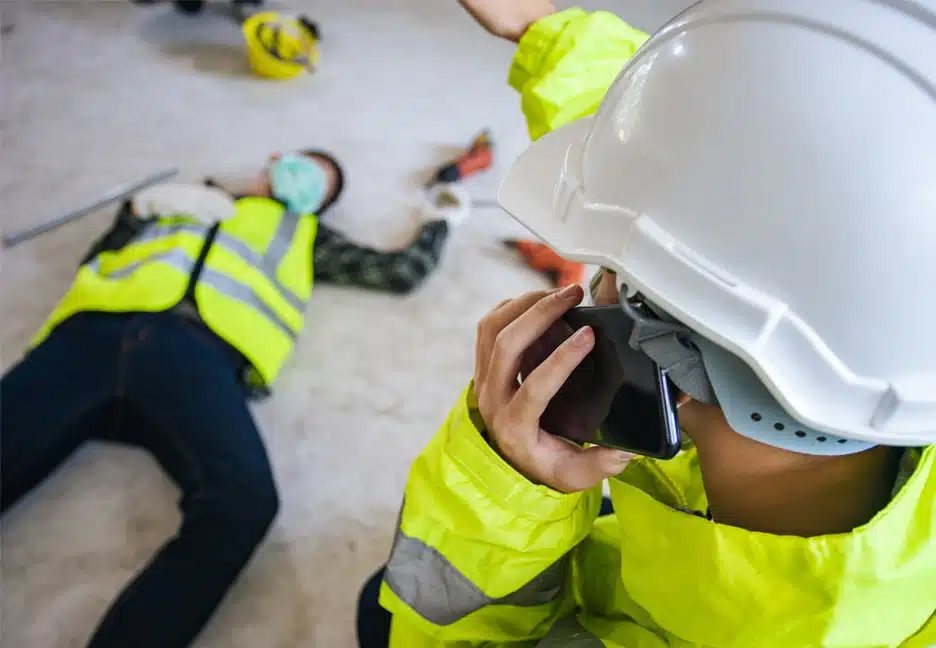 injured construction worker with supervisor calling for help