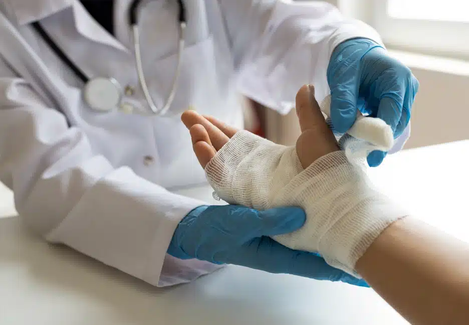 doctor bandaging patient's hand