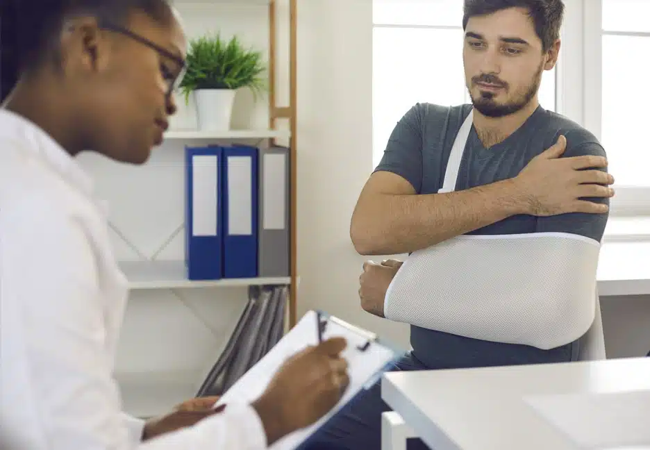 man with broken arm at doctor's office