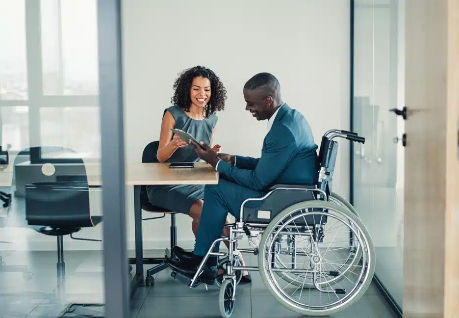 man in wheel chair meeting with employee